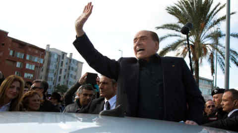 Former Italian Premier Silvio Berlusconi waves during a visit to Monserrato, near Cagliari, Italy, Thursday, Jan. 17, 2019. The three-time Italian premier, who has made a career out of rebounding from legal woes, personal scandal, heart trouble and political setbacks, said he is running for the European Parliament in May elections. The 82-year-old Berlusconi announced his candidacy with his center-right Forza Italia party Thursday in Sardinia. He said he wanted to "bring my voice to a Europe that should change, a Europe that has lost profound thinking about the world." (Fabio Murru/ANSA via AP)